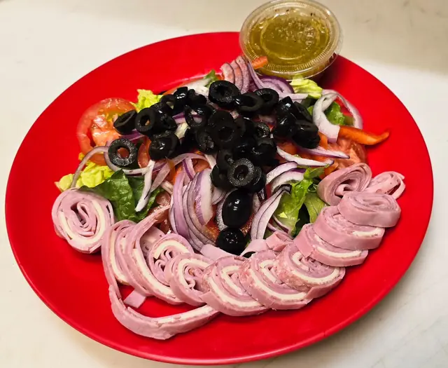 Antipasto salad with rolled ham, black olives and red onion