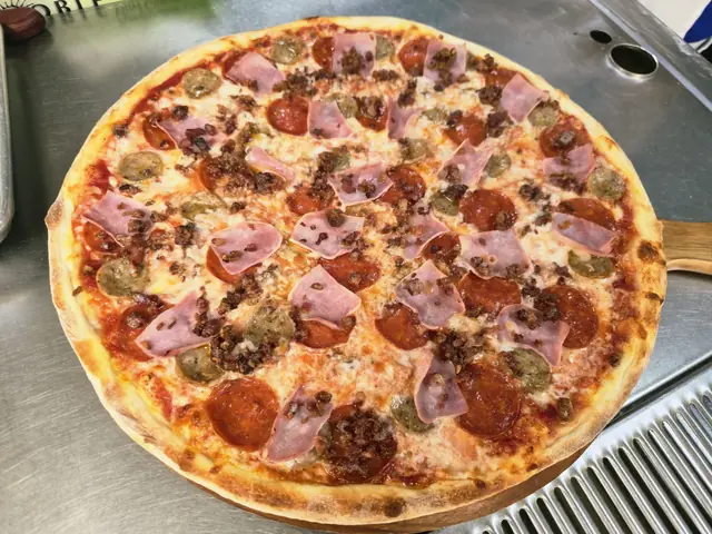 Meat lover pizza with pepperoni, ham, sausage and beef